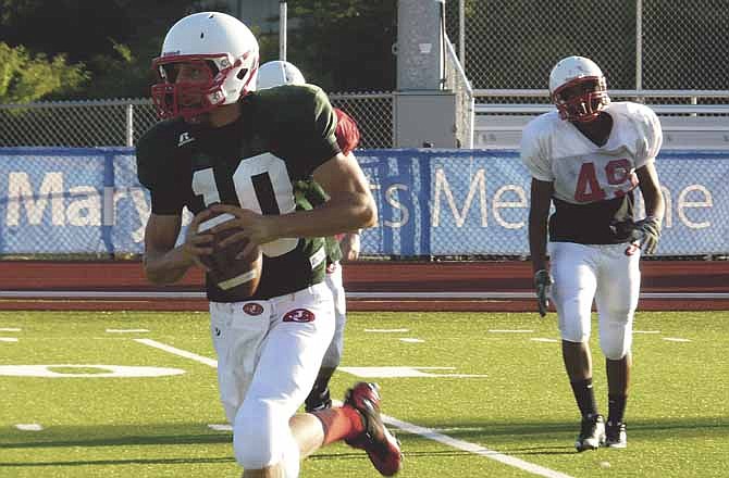 Jays quarterback Thomas LePage (foreground) runs with the football during Friday night's scrimmage at Adkins Stadium in Jefferson City.