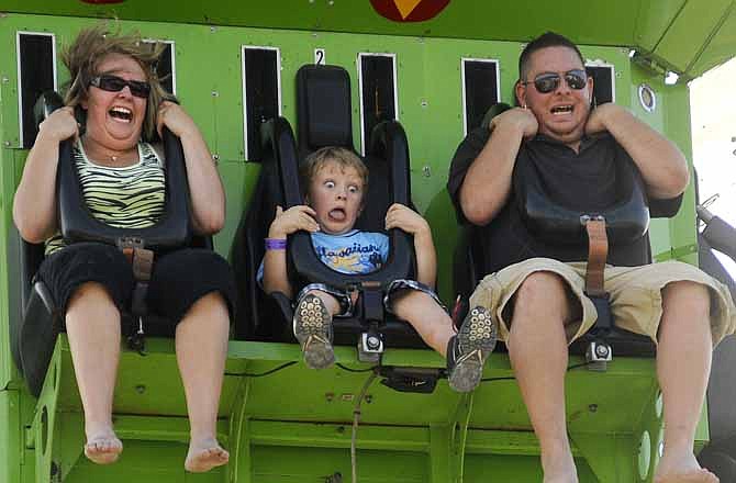 In this file photo from 2011, eight-year-old Ryan Backues, center, gets more of a drop than he bargained for while riding the Super Shot ride with Mallory Maddox, left, and Clint Ainsworth, right, at the Jefferson City Jaycees Cole County Fair.