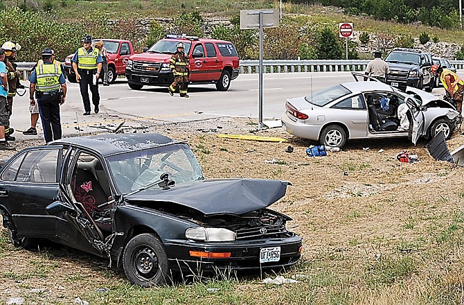 Cole County First Responders respond to the scene of a fatal two-car crash Monday afternoon, July 30, 2012, at the new westbound U.S. 54 and Buffalo Road crossover. 