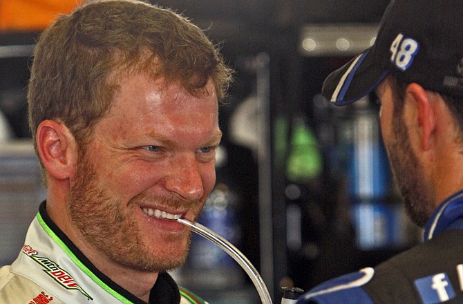 Dale Earnhardt, Jr. (left) shares a laugh with fellow driver Jimmie Johnson earlier this year. Johnson won Sunday's Sprint Cup race at the Brickyard in Indianapolis, but Earnhardt now has the points lead.