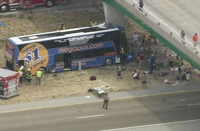 In this photo from video provided by KSDK-TV NewsCenter5 in St. Louis, first responders work the scene of a charter bus crash on Interstate 55 near Litchfield, Ill. Thursday, Aug. 2, 2012. The double-decker Megabus carrying 81 passengers blew a tire and slammed head-on into a concrete bridge support pillar.