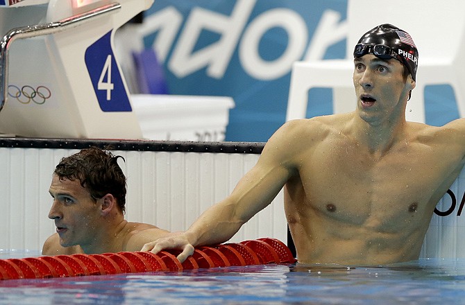 Michael Phelps (right) stands with next to U.S. teammate Ryan Lochte after winning the men's 200-meter individual medley final Thursday in London.