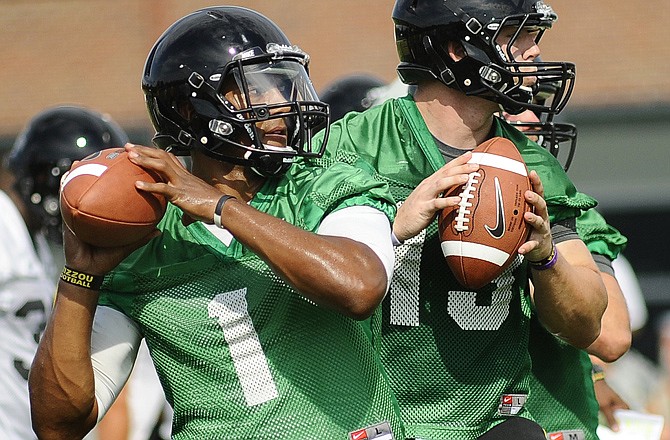 Missouri quarterbacks James Franklin (1) and Corbin Berkstresser go through drills Thursday afternoon in Columbia.