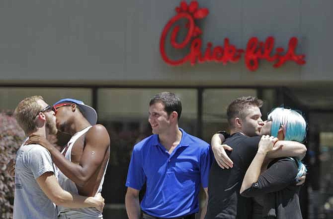 Protesters take part in a "Kiss In" outside a Chick-fil-A restaurant on Friday, Aug. 3, 2012 in Atlanta. Gay rights activists are planning demonstrations at Chick-fil-A restaurants to protest the fast-food chain owners' opposition to same-sex unions. (AP Photo/Atlanta Journal-Constitution, Bob Andres)