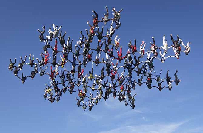 In this image provided by Brian Buckland, 138 skydivers form a massive snowflake formation Friday, Aug. 3, 2012 over Ottawa, Ill. Three judges representing the Federation Aeronautique Internationale, the international air sports agency, certified that 138 skydivers created the formation over Ottawa, about 80 miles southwest of Chicago. It took 15 attempts over three days for the team to break the previous record of 108 skydivers, which was set in 2009. 