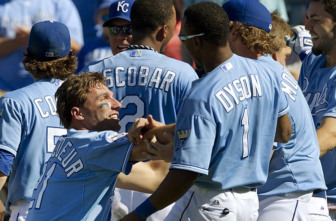 Members of the Royals celebrate their win over the Rangers on Sunday in Kansas City.