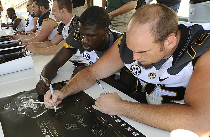 Missouri Tigers Dorial Green-Beckham (left) and Elvis Fisher sign autographs at Sunday's Fan Day in Columbia.