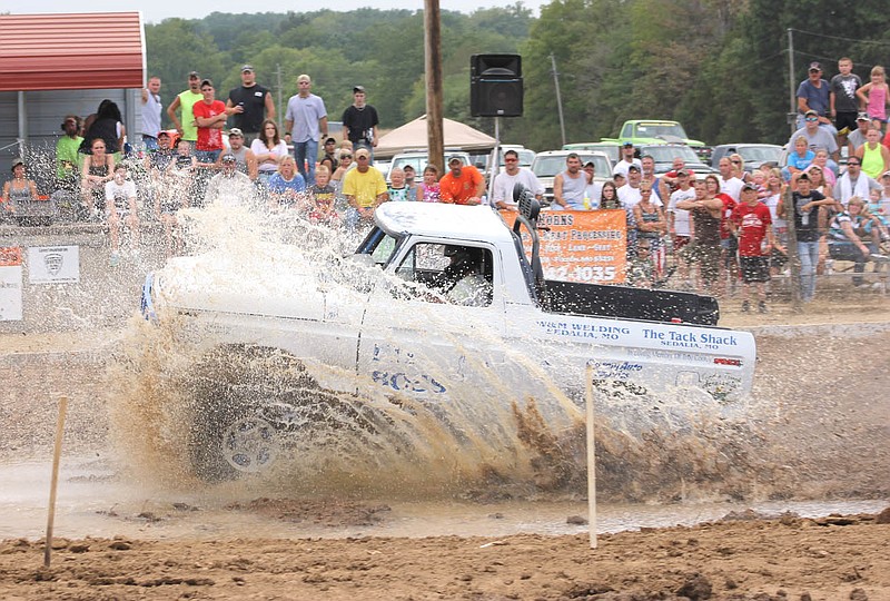 New to the Kingdom of Callaway County Fair this year was the mud bog held in the large arena Saturday night. A pair of bulldozers spent a good portion of Saturday morning and earlyafternoon digging "bogs" and building "hills" to be watered down in preparation for testing area trucks and drivers.