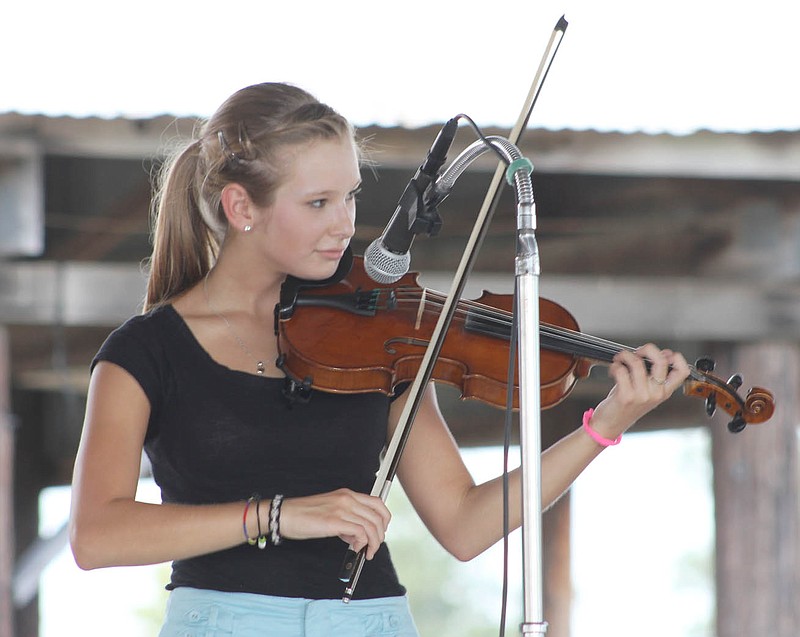 Olivia Cunningham of Fulton plays in the Old Time Fiddle Contest at the Kingdom of Callaway County Fair Saturday afternoon. Cunningham won first place in the youth division, taking home a trophy and a $75 prize.