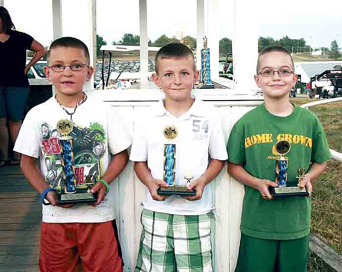 Winners of the 50-75 lbs. division of the Kiddie Tractor Pull Monday night at the fair, from left, are: first place, Carter Petree, 8, son of Garret and Shonda Petree, Tipton; second, Garett Swearingen, 7, son of Chris Swearingen and Trisha Scheidt, California; and third, Matthew Bolfing, 9, son of Charles and Dianna Bolfing, McGirk.