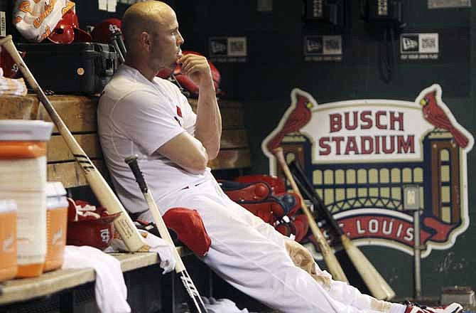 St. Louis Cardinals' Matt Holliday sits in the dugout in the eighth inning of a baseball game against the San Francisco Giants, Wednesday, Aug. 8, 2012, in St. Louis. The Giants won 15-0. 