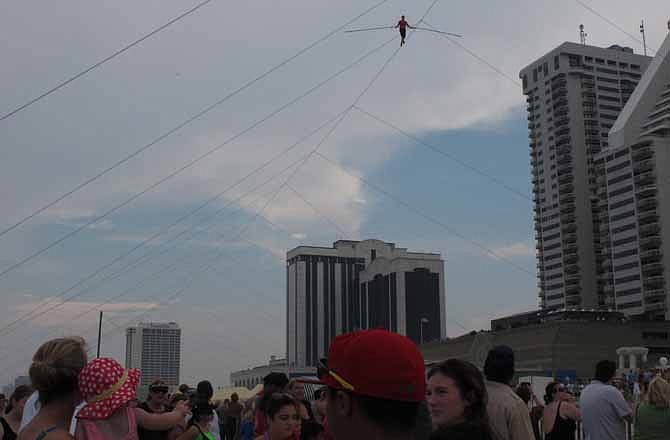 A crowd watches as daredevil Nik Wallenda walks a tightrope above the beach at Atlantic City on Thursday, Aug. 9, 2012. Officials say some 150,000 people witnessed the walk.