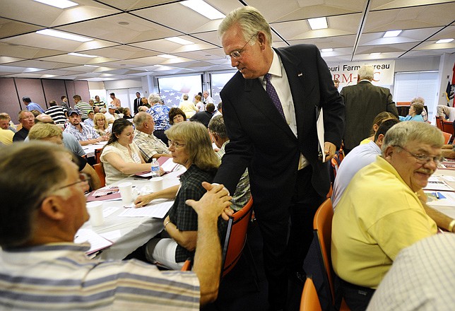 Governor Jay Nixon makes his way through the room after speaking to a crowd of more than 200 farmers and ranchers from across the state at the Missouri Farm Bureau's FARM-PAC endorsement session Friday morning.