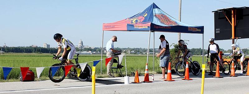 A racer leaves the starting line at 9 a.m. Saturday at the start of day-long time trials as racers compete against the clock for the 2012 Missouri State Bicycle Championship. With the Missouri Capitol and the Jefferson City skyline in the background, the time trials were held in Callaway County on a relatively flat 12.5 mile course along Missouri 94 near the Missouri River.