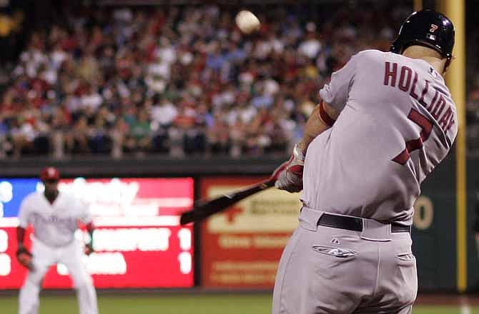 St. Louis Cardinals' Matt Holliday, right, hits a three-run home run in the sixth inning of a baseball game with the Philadelphia Phillies, Saturday, Aug. 11, 2012, in Philadelphia. The Cardinals won 4-1.