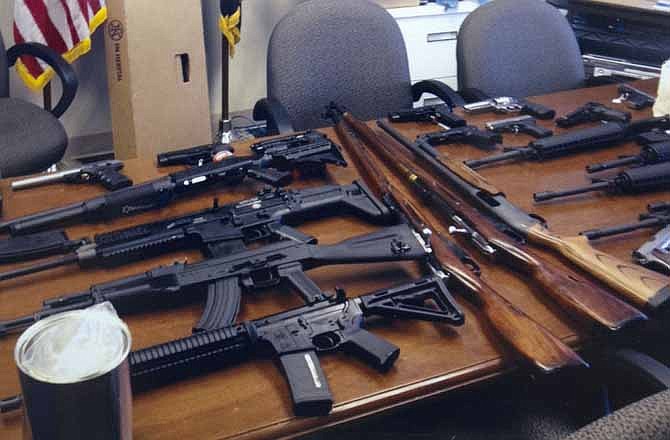 This undated handout photo provided late last month by the Prince George's, Md. County Police shows weapons found in the possession of a suspect who they say was plotting a shooting in his workplace. He faces a misdemeanor charge for allegedly making threats over the telephone.
