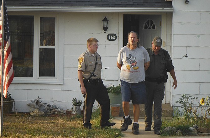 Law enforcement officers arrest Patrick W. Stefanski, 51, Friday night at his Vienna, Mo., home, where he's suspected of selling illegal drugs. (Photo courtesy of Maries County Sheriff's Dept)