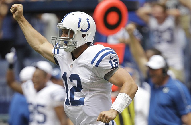 Colts quarterback Andrew Luck celebrates after throwing a touchdown pass against the Rams in the first half Sunday in Indianapolis. St. Louis lost 38-3.