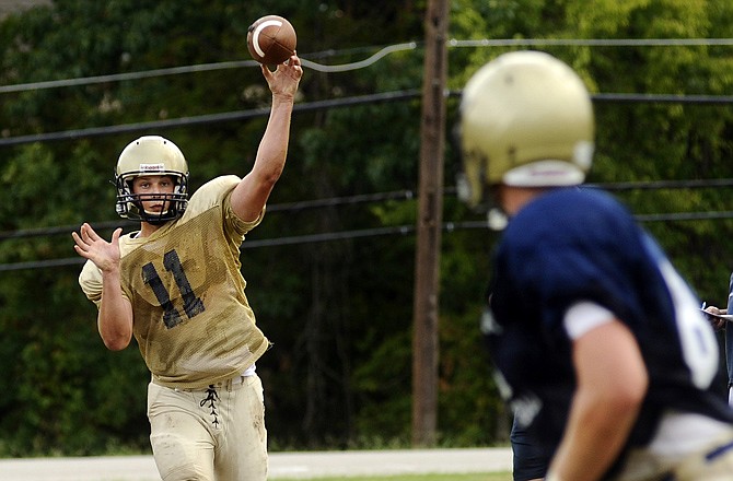 Helias quarterback Trent Dudenhoeffer fires a quick slant to Hale Hentges during an intersquad scrimmage Tuesday at Helias.