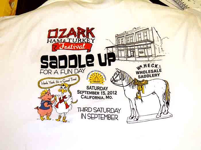 T-shirts for the 2012 Ozark Ham and Turkey Festival are available at the Chamber office for $15, and feature this year's theme which is "Saddle Up for a Fun Day" in connection to W.M. Heck's Wholesale Saddlery. The shirts come in gray, white, pink and yellow and go from youth sizes to XXXL.