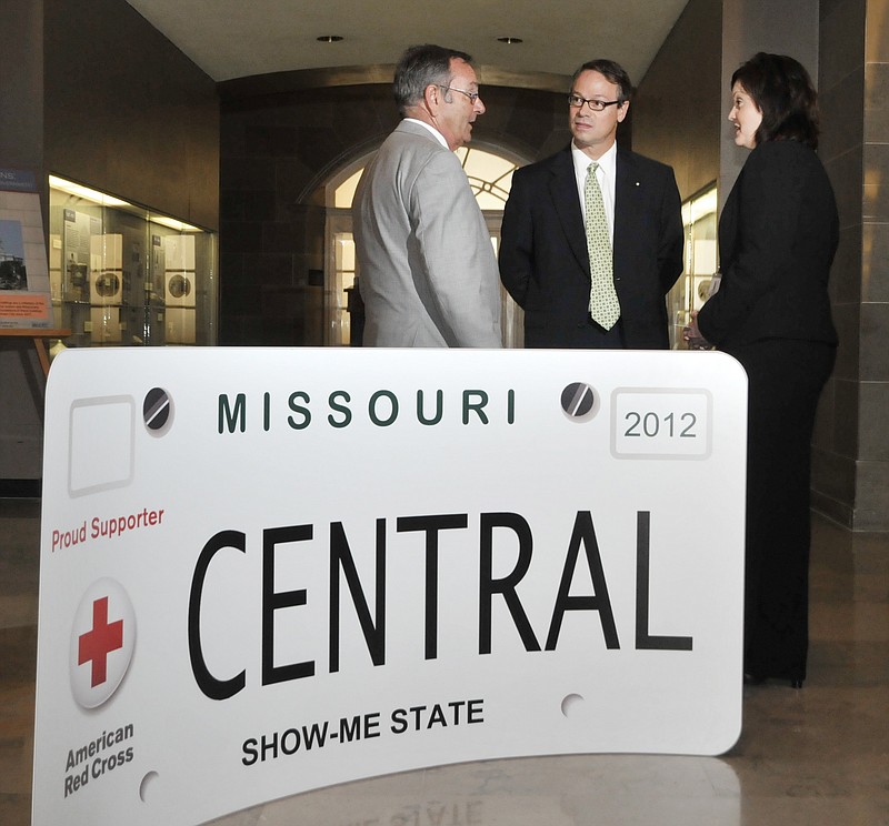 Dave Griffith, left, visits with Bob Jones and Jami Peebles, right, Wednesday in the Capitol Rotunda. Representatives from various Missouri chapters the American Red Cross were at the Capitol to introduce a new item to support the Red Cross. The license plate in the foreground was unveiled and introduced to the public. Griffin is executive director of the American Red Cross Heart of Missouri chapter, and Peebles is volunteer chair for the Southwest Missouri chapter.