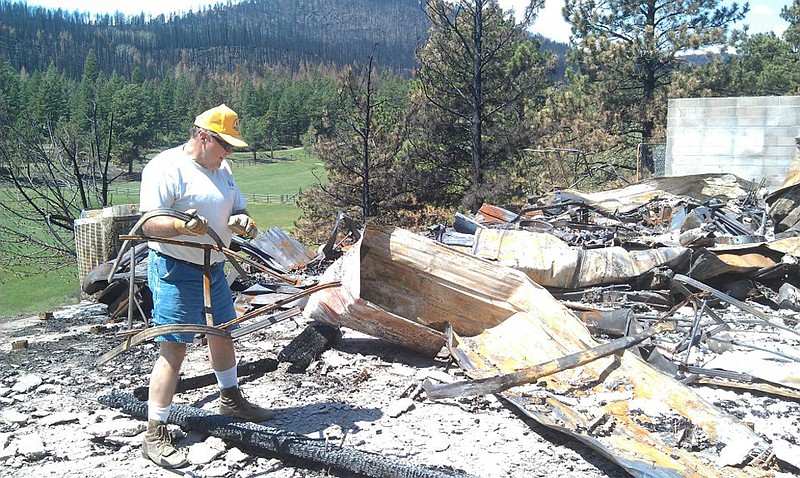 David Hamilton of Hatton sifts through ash and rubble in the aftermath of the Colorado wildfires last July. Hamilton went on a disaster-relief volunteer trip to the state, along with 12 other Missourians.