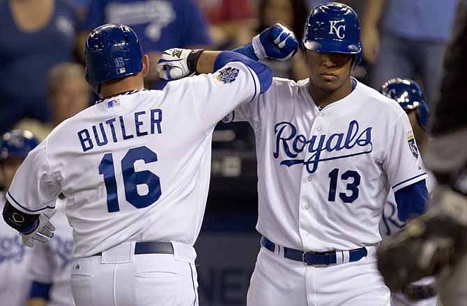 Kansas City Royals' Billy Butler (16) is congratulated by teammate Salvador Perez (13) after his solo home run during the sixth inning of a baseball game against the Chicago White Sox at Kauffman Stadium in Kansas City, Mo., Friday, Aug. 17, 2012. 