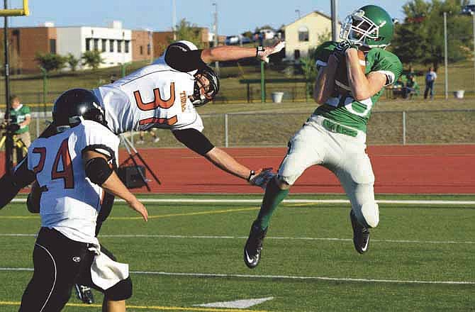 Blair Oaks' Ashton Maasen hauls in a 40-yard touchdown pass from Daniel Castillo against Kirksville during Friday's Jamboree at the Falcon Athletic Complex in Wardsville, Mo.