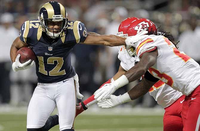 St. Louis Rams wide receiver Steve Smith, left, runs with the ball past Kansas City Chiefs defensive back Kendrick Lewis after catching a pass for a 10-yard gain during the first quarter of a preseason NFL football game on Saturday, Aug. 18, 2012, in St. Louis. 