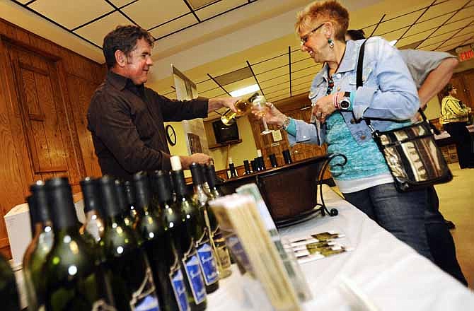 Ladies Auxiliary member Debbie Hemmel, right, has a sample of wine poured by Summit Lake Winery owner John Ferrier during the 6th annual Sip 4 Life benefit auction and wine tasting at the Jefferson City Eagles Club in April. The Eagles Club is celebrating its 65th anniversary this month.