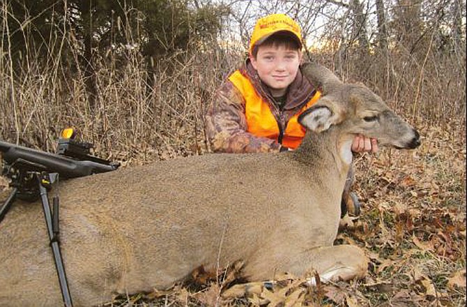 Jacob Vogt poses with his first whitetail deer.