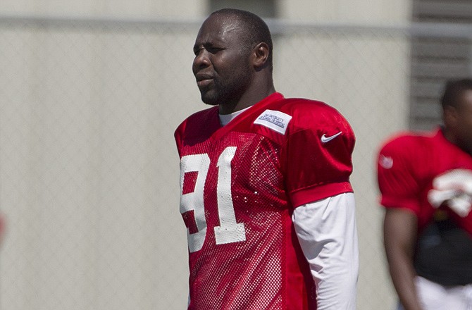 Chiefs linebacker Tamba Hali walks between fields Monday at the team's training facility in Kansas City.