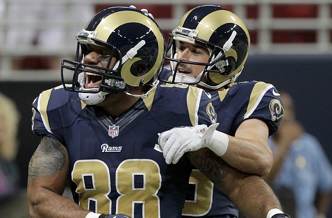 Rams tight end Lance Kendricks (88) is congratulated by teammate Danny Amendola after catching a 23-yard touchdown pass during Saturday's game against the Chiefs.