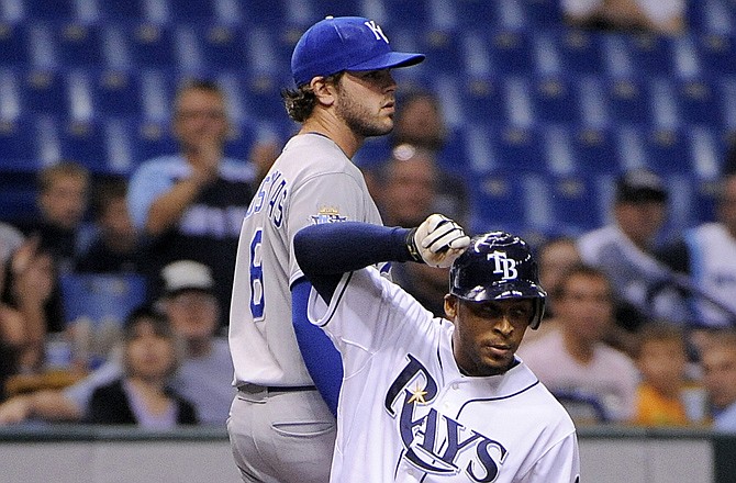 Desmond Jennings of the Rays slides safely into third base ahead of Mike Moustakas of the Royals on Monday in St. Petersburg, Fla.