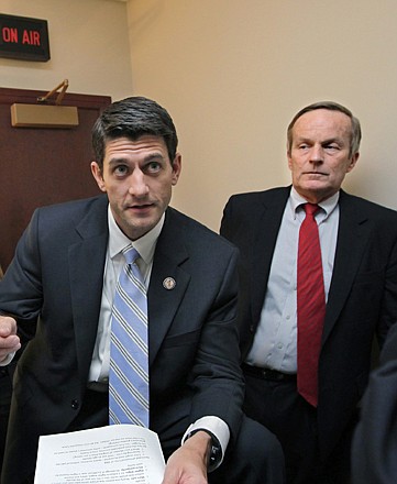 Missouri Rep. Todd Akin, right, listens to Paul Ryan, R-Wis., before a news conference on Ryan's budget agenda in April 2011, on Capitol Hill in Washington. Akin's Senate campaign is under fire after he "misspoke," and other Republicans are withdrawing their backing of him.