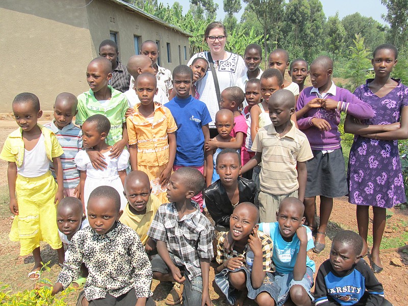 One of 10 local volunteers to make the annual summer trip to Rwanda, Allie Barden poses with some of the local children after church. Barden is staying in Rwanda as a volunteer with the Rwanda Community Partnership and Humanity for Children.                                