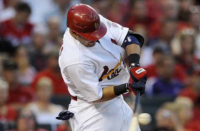 Yadier Molina of the Cardinals hits an RBI single during Tuesday's game with the Astros at Busch Stadium.