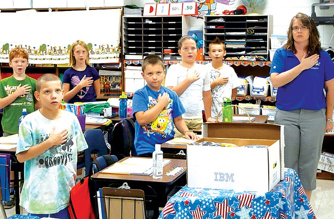 Cindy Wieberg's fourth-graders recite the Pledge of Allegiance on Russellville's first day of school.
