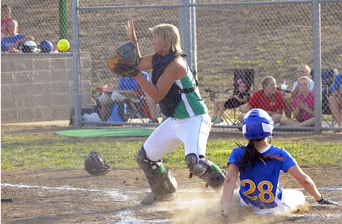 Blair Oaks catcher Amy Dorge waits for the ball as Kristen Boeckmann of Fatima slides across the plate during Thursday's game at the Falcon Athletic Complex.