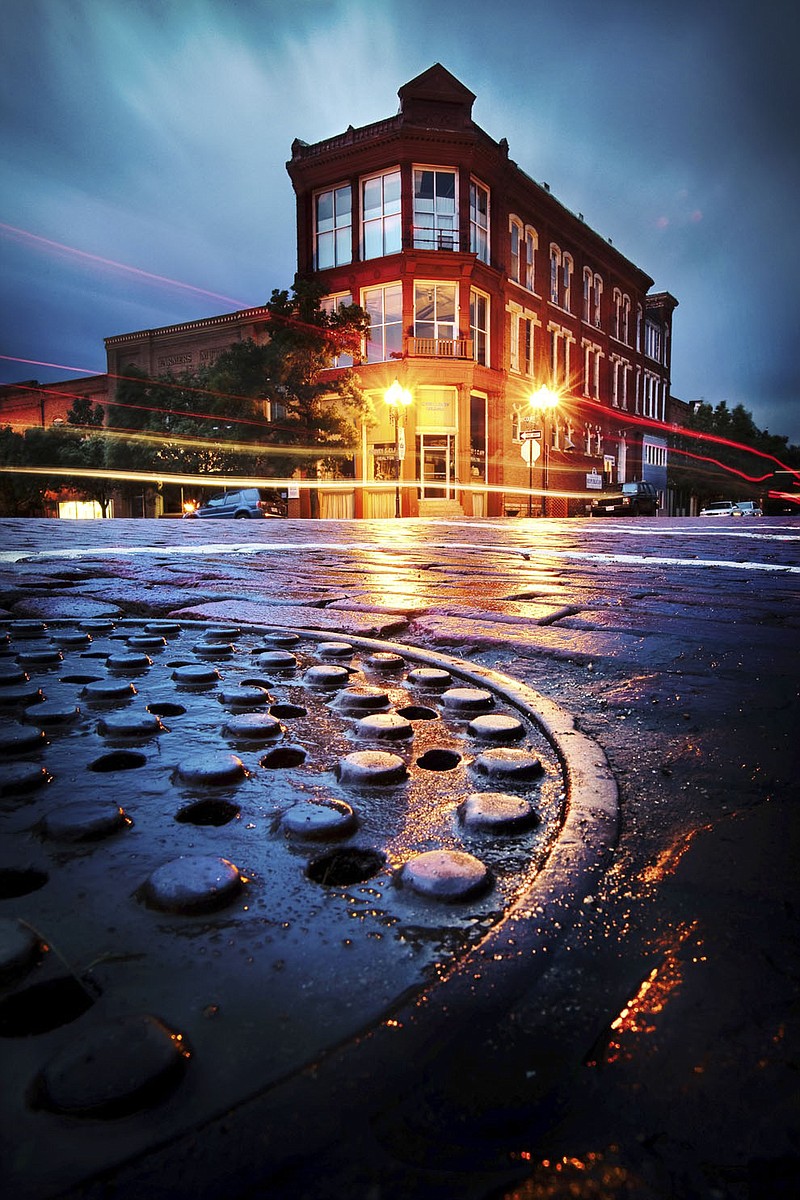A Notley Hawkins photograph of a 5th Street manhole in downtown Fulton is one of many on display in Cox Gallery for the "From Life" exhibit. An Ovid Bell employee, Hawkins has been photographing Fulton and mid-Missouri since 2005.