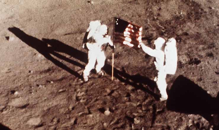 In this July 20, 1969 file photo provided by NASA shows Apollo 11 astronauts Neil Armstrong and Edwin E. "Buzz" Aldrin, the first men to land on the moon, plant the U.S. flag on the lunar surface. The family of Neil Armstrong, the first man to walk on the moon, says he has died at age 82. A statement from the family says he died following complications resulting from cardiovascular procedures. 