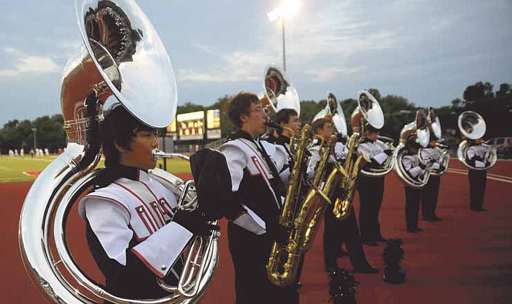 Jefferson City tuba player Kangho Eom warms up with the band prior to the halftime show Friday evening at the football game in Adkins Stadium.