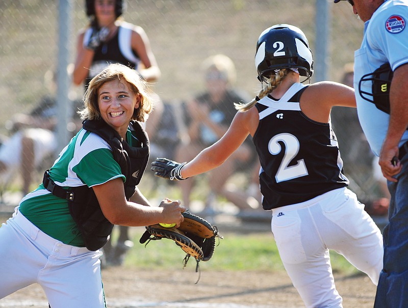 Blair Oaks catcher Amy Dorge looks to the field and holds onto the ball Monday after tagging out Centralia's Kailee Chitwood in a game at the Falcon Athletic Complex.