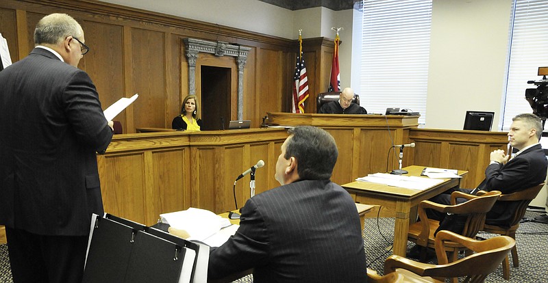 Jay Kanzler stands before Judge Daniel Green, background, while Chris Kanzler, foreground right, and Jeremiah Morgan, at right, listen during a hearing Tuesday. The Kanzlers represent Lt. Governor Peter Kinder and Morgan represents Robin Carnahan in the lawsuit challenging the ballot title on a measure on health care exchanges.