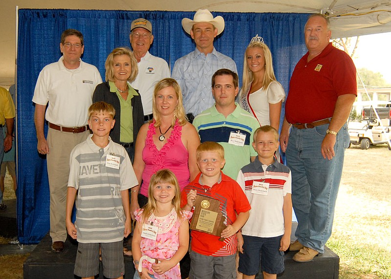 2012 Callaway County State Fair Family.  Pictured in the front row left to right:  Amelia, Caleb and Drew Rohrbach.  In the middle row left to right: Ean, Sarah and Roy Rohrbach. In the back row left to right:  Michael Ouart, Vice Provost, Office of Research & Extension; Sherry Jones, Missouri State Fair Commission; Jack Magruder, Missouri State Fair Commission; Jon Hagler, Director, Missouri Department of Agriculture; Emily Wood, 2012 Missouri State Fair Queen; Ronald Scheiderer, Missouri State Fair Commission.