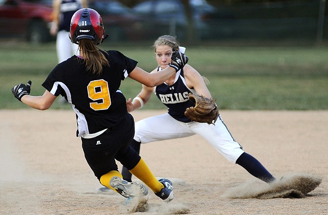 Helias shortstop Alex McDonald gets set to put the tag on St. Elizabeth's Megan Kemna as she tries to steal second base during Wednesday's game at Duensing Field.