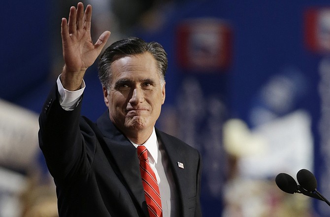 Republican presidential nominee Mitt Romney waves to delegates before speaking Thursday at the Republican National Convention in Tampa, Fla.