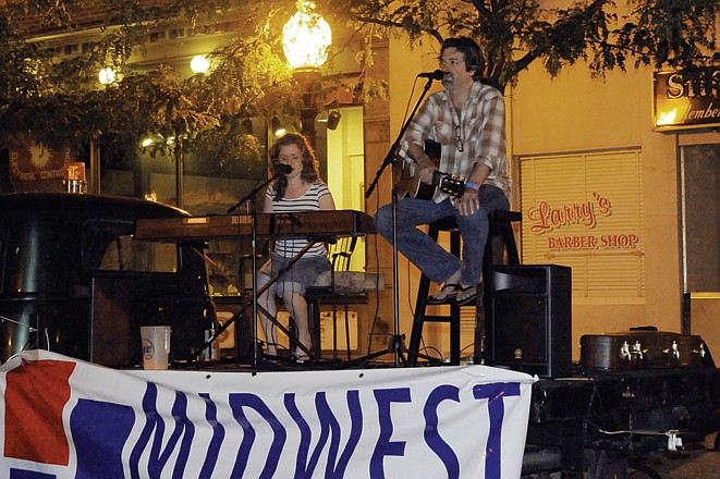 Kevin Montgomery and Ruth Trimble played on the back of truck Tuesday evening on Madison Street. Montgomery is on tour to raise awareness for youths aging out of the foster care system.