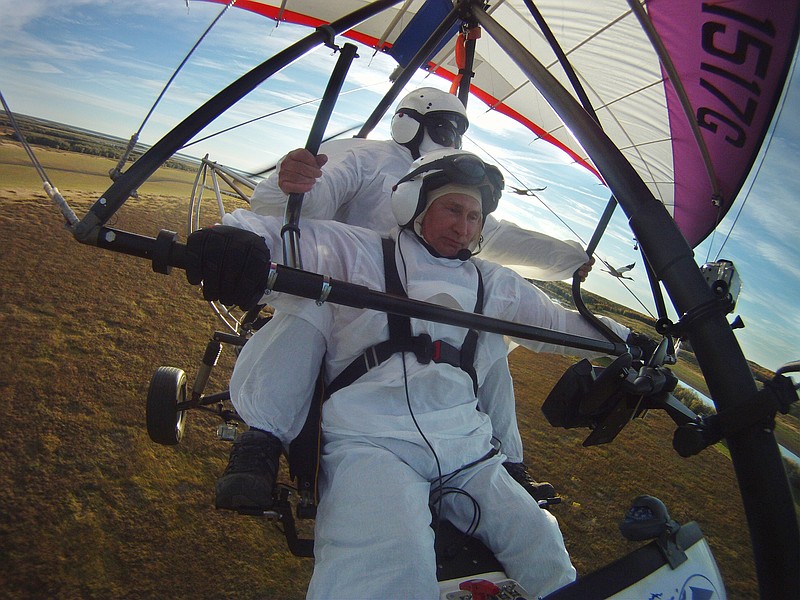 Russian President Vladimir Putin, (foreground) flies in a motorized hang glider alongside two Siberian white cranes Wednesday on the Yamal Peninsula, in Russia. Putin took part in a flight as part of a program devised by environmentalists to lead the endangered cranes, which were raised in captivity, on their migration to Asia.