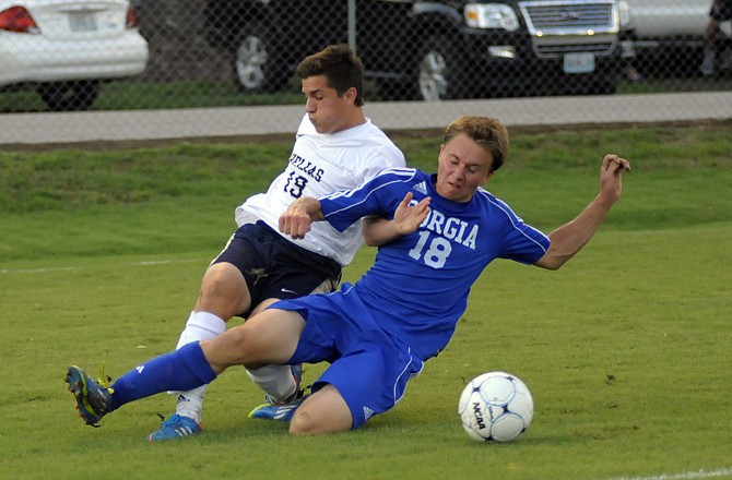 Dominic Salamone of Helias and Andrew Beckermann of Borgia battle for the ball during Thursday night's game at the 179 Soccer Park.